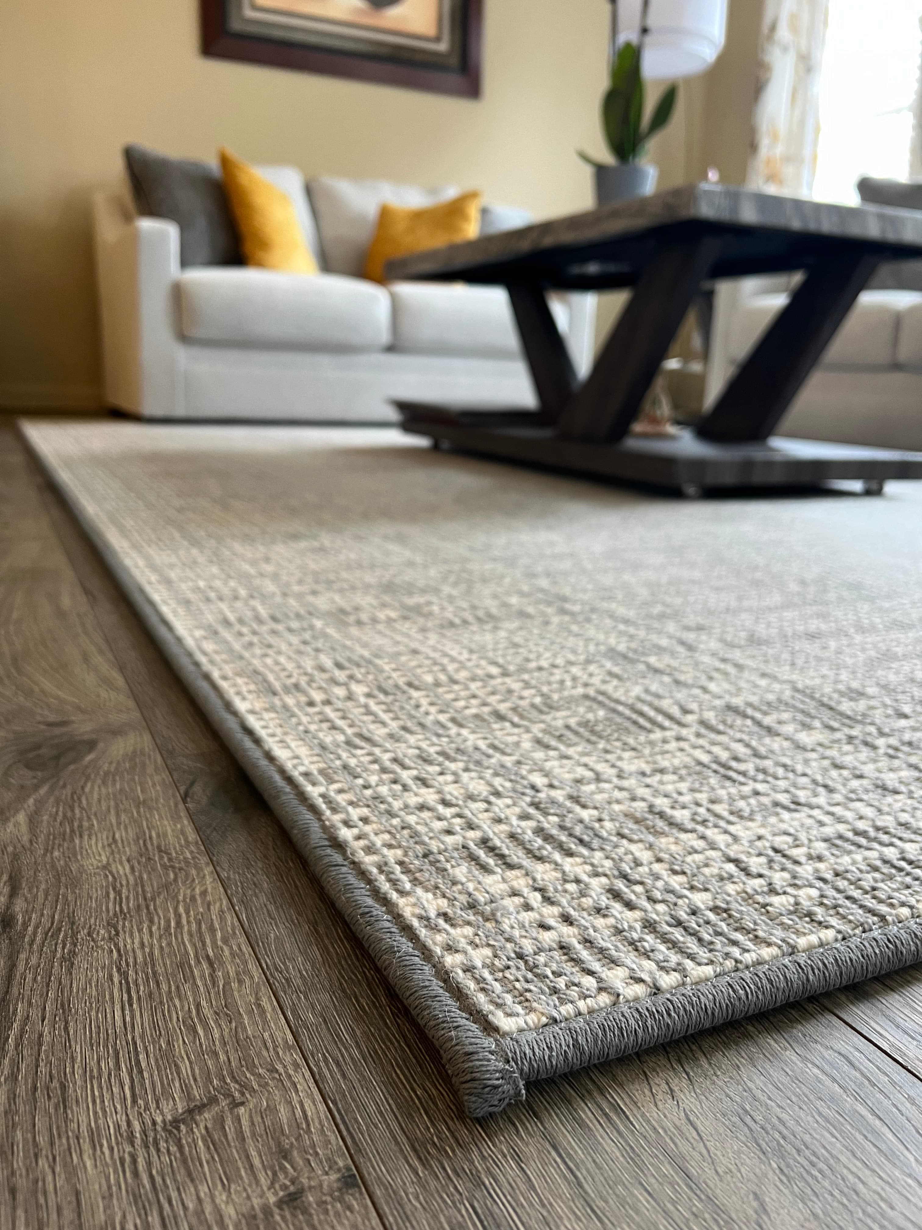 Overhead view of custom cream stair runner with brown binding on oak staircase in Northern Virginia home